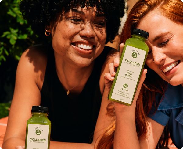 Two smiling women outdoors holding bottles of A Little Care Collagen drink, with one woman in the foreground holding a green collagen drink bottle labeled 'Pina Colo'.